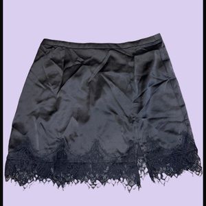 Pretty Urban outfitters silk black mini skirt with slit and lace trim!